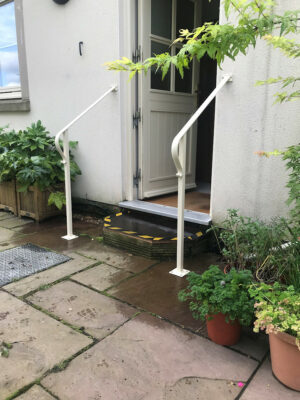 A pair of simple white metal hand-rails (by Derbyshire Dales Engineering)