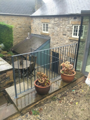 A simple small corner railing to a raised patio eating area (by Derbyshire Dales Engineering)