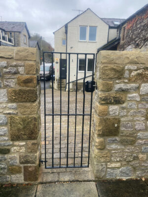 A tall thin metal gate (by Derbyshire Dales Engineering)