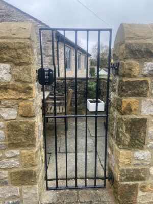 A tall thin metal gate (by Derbyshire Dales Engineering)