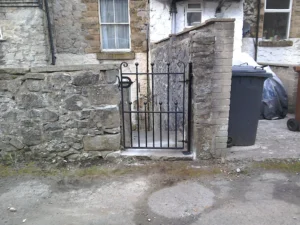 An ornate, custom-designed black metal gate