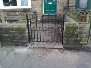 An ornate, custom-designed black metal gate