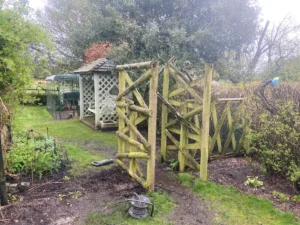 Rotten wooden fence and struction replaced with metal railings and gate (during installation)