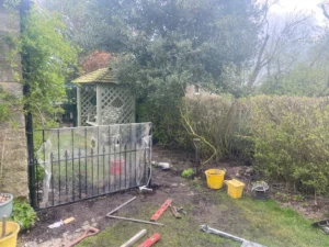 Rotten wooden fence and struction replaced with metal railings and gate (mid-installation)